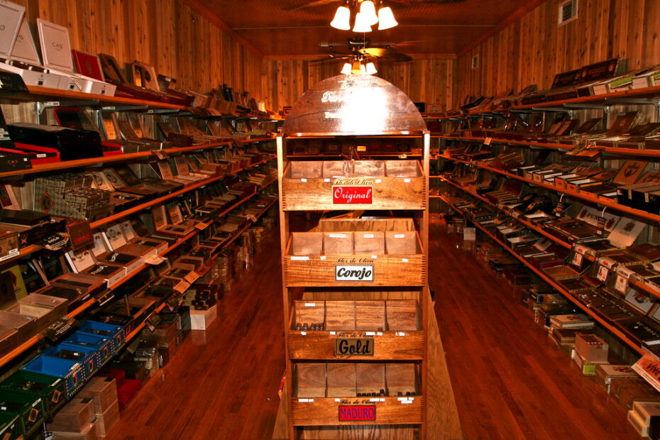 Aisle of a walk-in cigar humidor lined with cigar boxes